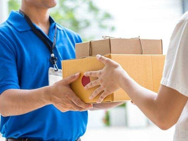 Courier delivering parcels to a client