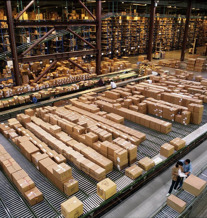 Parcels moving along warehouse conveyors